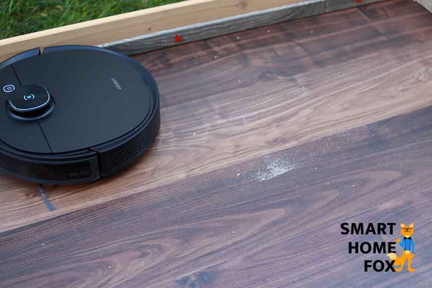 Im Test reinigt der Ecovacs Deebot T9 AIVI Sand auf dem Laminatboden